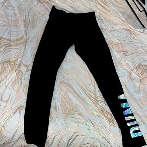 Black PUMA leggings. Holographic side logo on the left